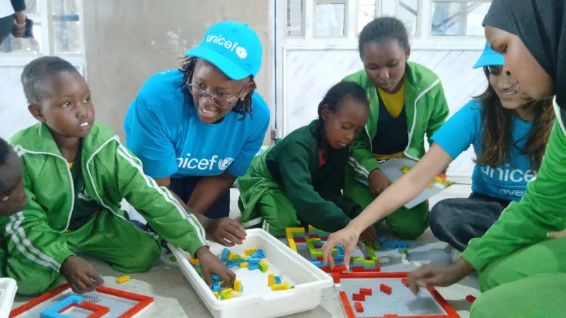 Unicef Kenya Education officer Elizabeth Waitha joins learners in a Lego Braille Bricks game at Olkejuado Boys' Boarding School in Kajiado county on June 11 – GEORGE OWITI
