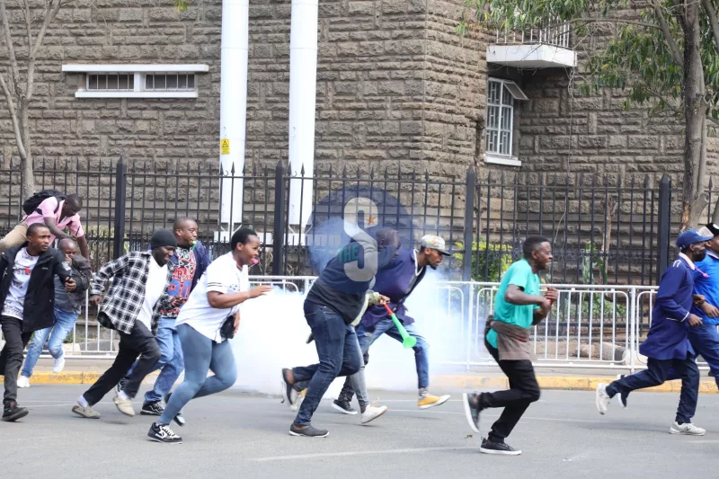 Business people run for safety as tear gas fills the streets during demonstrations by small-scale traders in Nairobi CBD on August 28, 2026. / EZEKIEL AMING’A