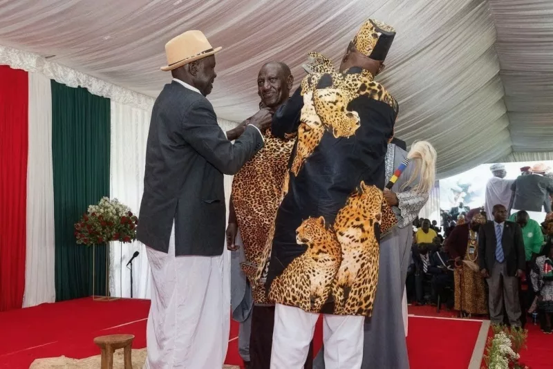 Caption: Teso Council of Elders chairman Wycliffe Oprong and ICU Deputy Prime Minister Fredrick Adung'o (left) decorate President Ruto in traditional Iteso regalia as Teso Elder at State Lodge, Eldoret on  Saturday/IMAGE/HILTON OTENYO