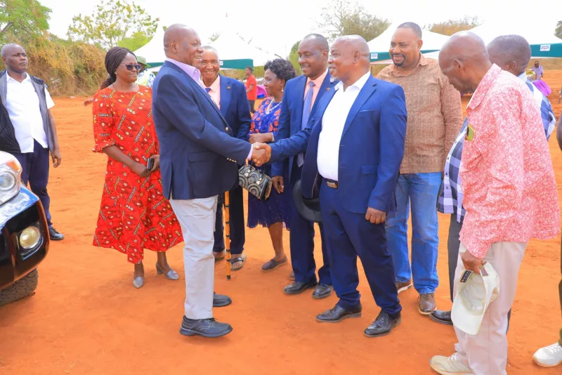 Kitui Governor Julius Malombe is received by Ikutha MCAS Hussein Mwandia on arrival in Kyoani village in Kitui south on Saturday.