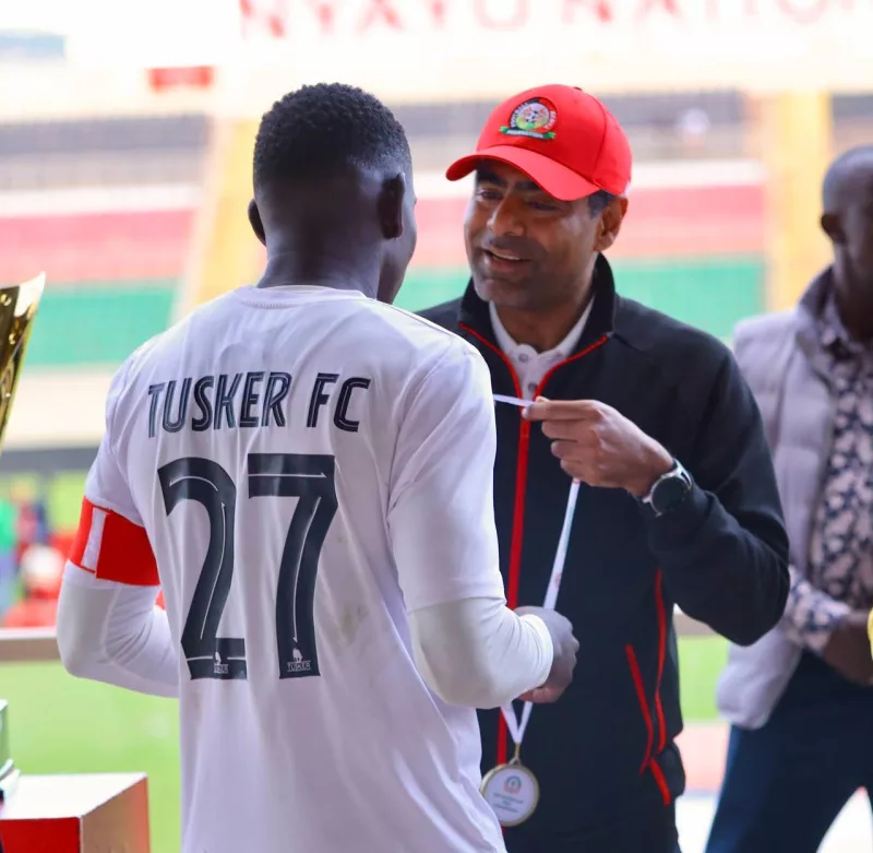 Tusker midfielder Chrispine Erambo with FKF president Hussein Mohammed at the Nyayo Stadium