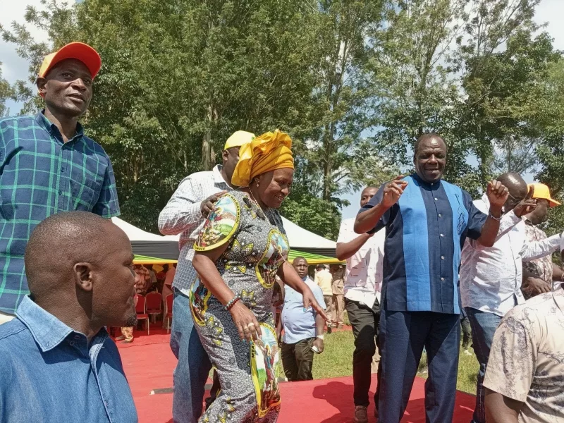 Kakamega woman MP Elsie Muhanda and Co-operatives Cabinet Secretary Wycliffe Oparanya in a jig during a development tour at Ebukokolo primary school in Emuhaya sub-county on Sunday/IMAGE/HILTON OTENYO