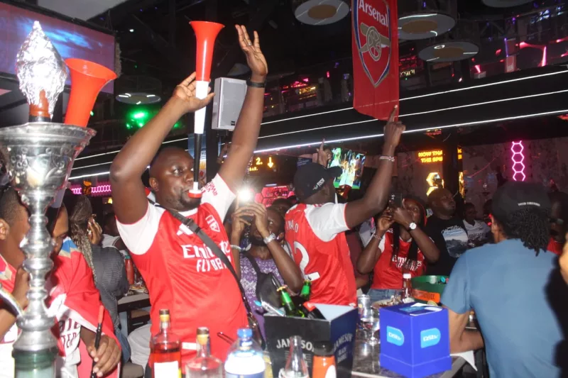 Arsenal fans celebrate at a club in Nairobi after their team lifted the EPL cup on Sunday, May 24 /MOSES MWANGI