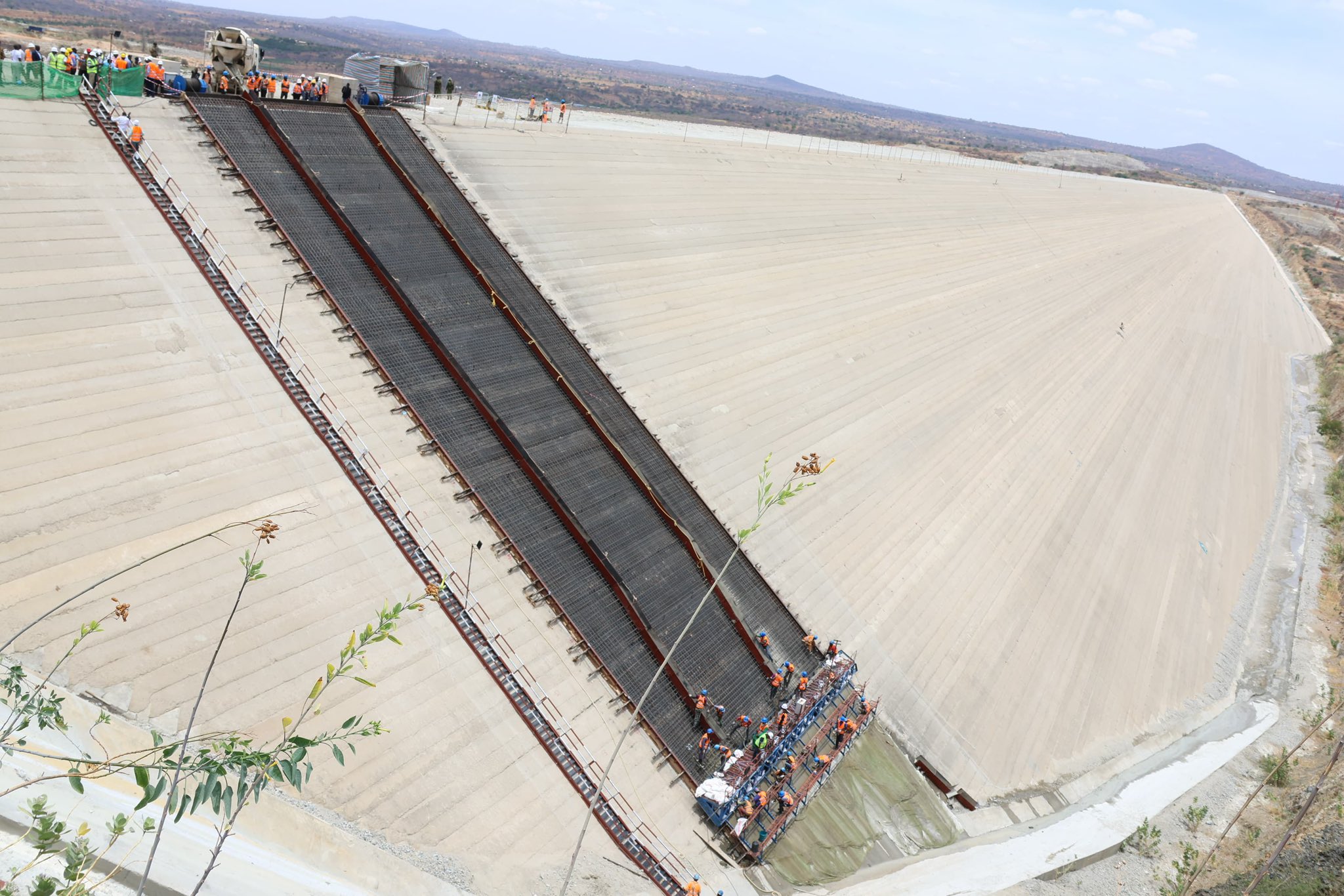 Workers at the Thwake Dam sit in September 2025.