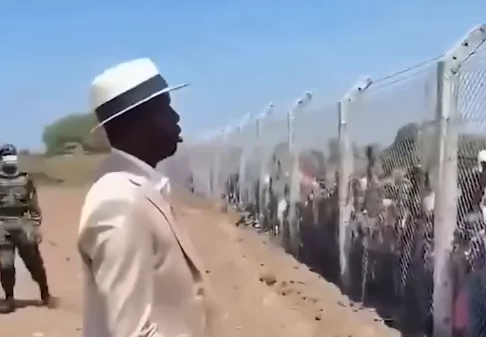 Raila Jnr explains address to residents behind fence