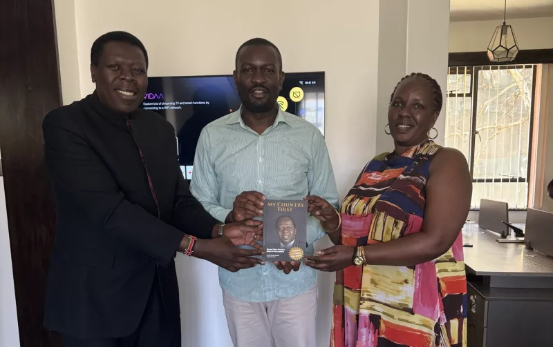Eugene hands Sifuna Kijana Wamalwa's book