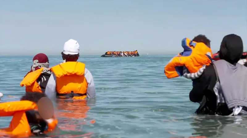 The BBC watched groups of migrants boarding an inflatable dinghy on the Gravelines beach in northern France/BBC