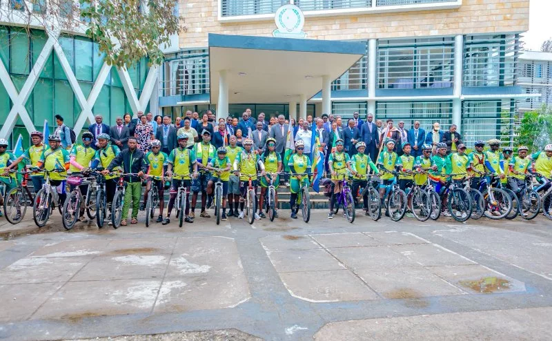 The cyclists line up with EAC officials before they were flagged off in Arusha