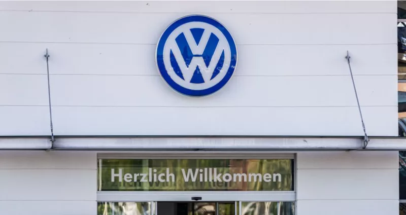 A man stands at an entrance of a car dealership of Volkswagen in Berlin, capital of Germany, May 7, 2020. (Photo by Binh Truong/Xinhua)