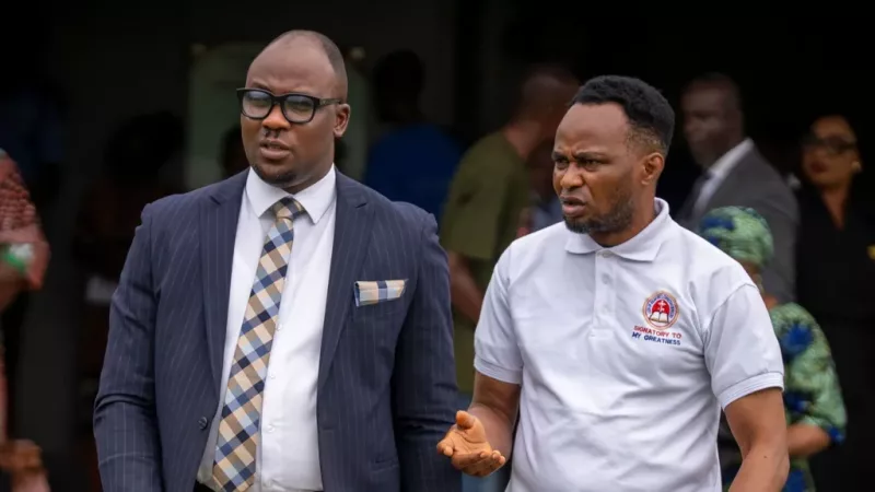 Adeniyi Mobolaji Kayode, right, leaves court with his lawyer on Thursday