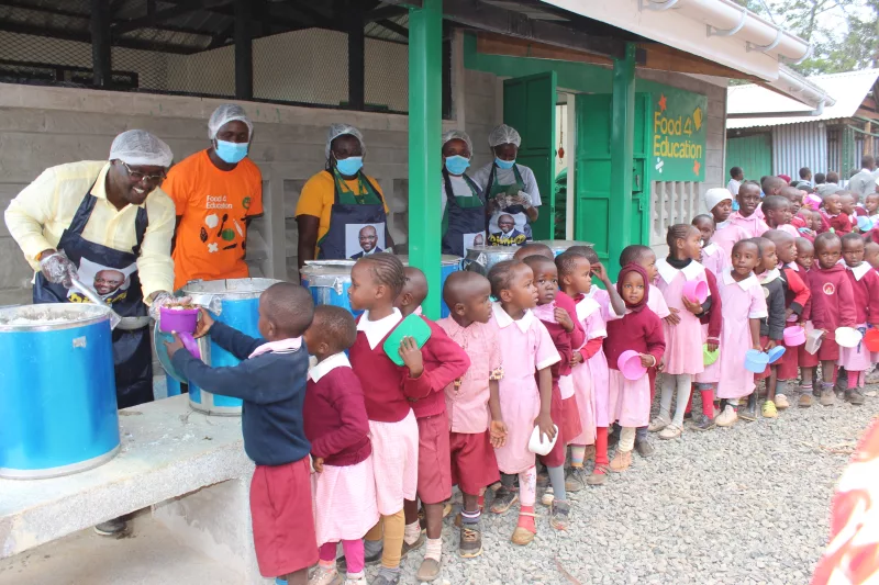 Gatanga MP Edward Muriu serving lunch to learners at Ngaatho primary school through a partnership with Food4Education on June 9, 2025/ ALICE WAITHERA