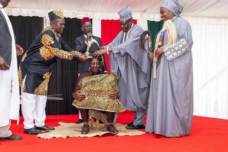 Cultural Leader Emorimor Paul Sande Emolot and his Deputy Prime Minister Fredrick Adung'o (left) install President William Ruto as Teso Elder at State Lodge, Eldoret Saturday. Looking on are Queen Ikwii Akaliat and Teso North MP Oku Kaunya ( in red cap)/IMAGE/HILTON OTENYO