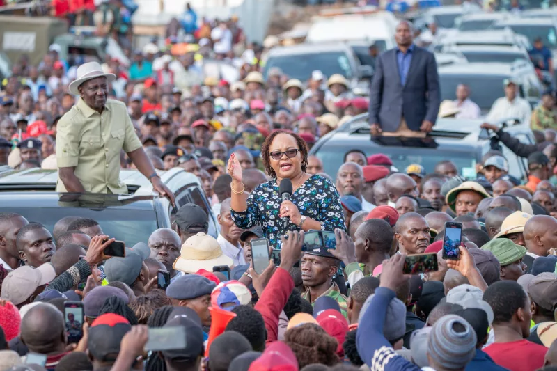 Kirinyaga  Governor Anne Waiguru addresses a crowd flanked by President William Ruto and DP Kithure Kindiki