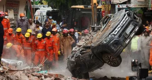 Rescuers race to free people trapped after building collapse in Delhi