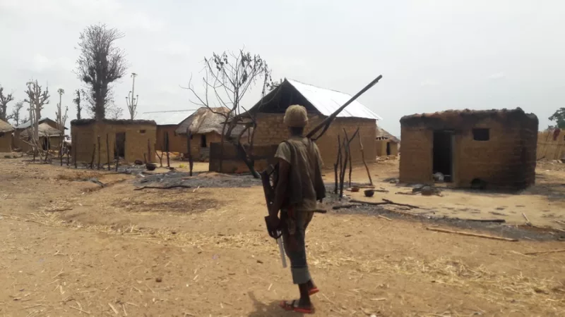 A file photo shows a man walks past burnt houses in Nigeria's northwest state of Kaduna on May 8, 2018. (Xinhua/Olatunji Saliu)