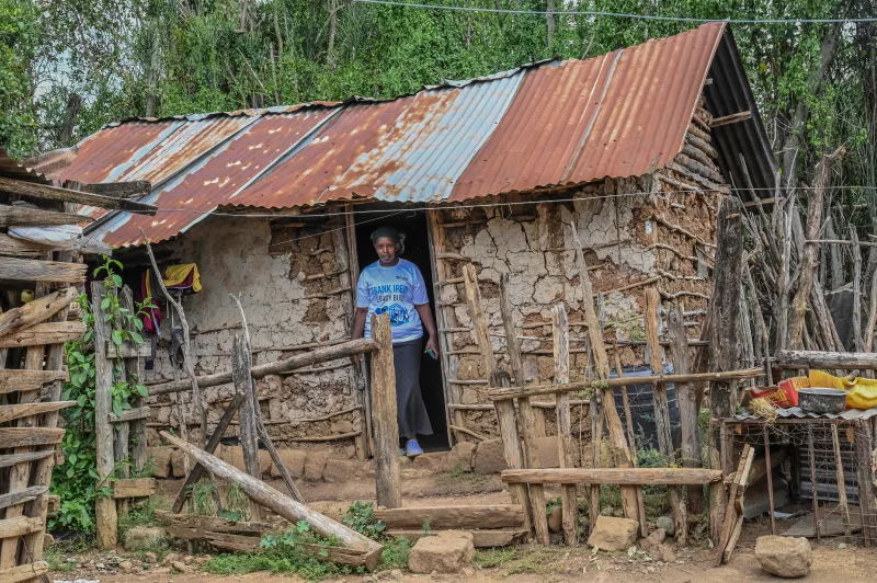 Zipporah Wambui, a widow, in her two-roomed mud-walled house that she shares with her children and late sister's orphans/ALICE WAITHERA