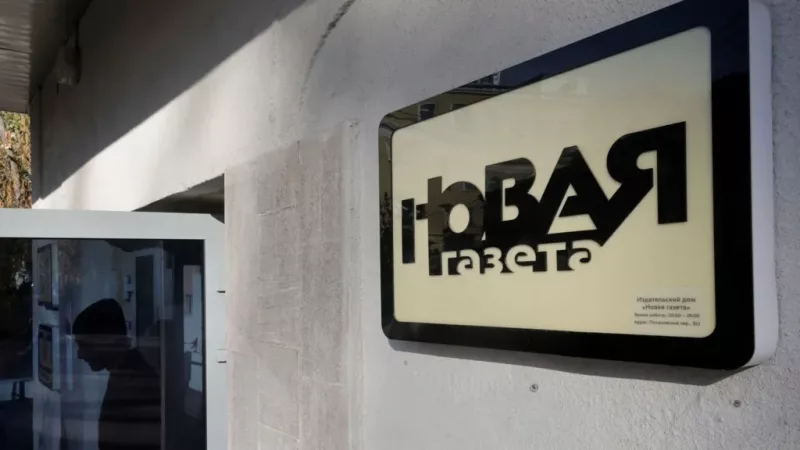 A person leaves the building of Novaya Gazeta after the paper announced it was closing