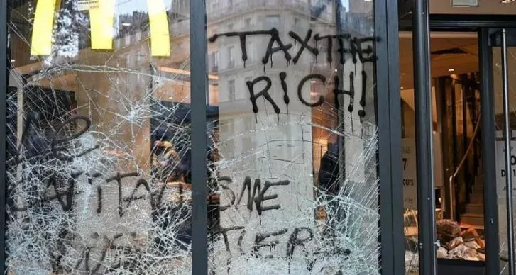 Burnt cars, shattered glass in Paris after protests