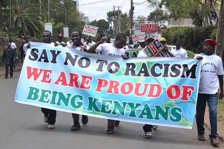 Youths carry an anti-racism banner at a demonstration in Nairobi / FILE