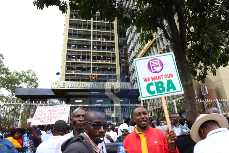 A lecturer holds a placard during the lecturers strike demonstrations at the University of Nairobi grounds,  Nairobi on October 15, 2026/LEAH MUKANGAI