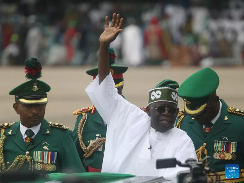 Bola Ahmed Tinubu (Front) waves to people after being sworn in as Nigeria's new president at a ceremony in Abuja, Nigeria, on May 29, 2023. (Photo by Sodiq/Xinhua)